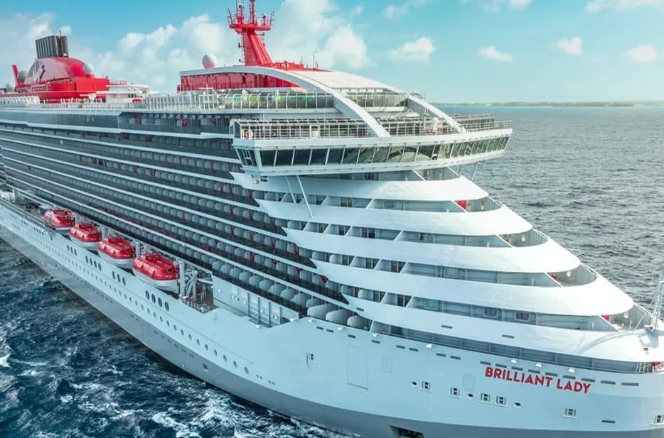 Virgin Voyages' Brilliant Lady at sea, name visible on the bow