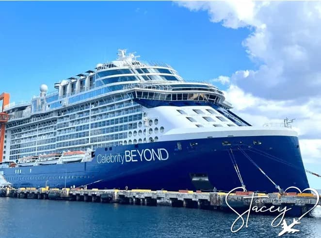 Celebrity Beyond docked at a pier, her name visible along the dark blue hull