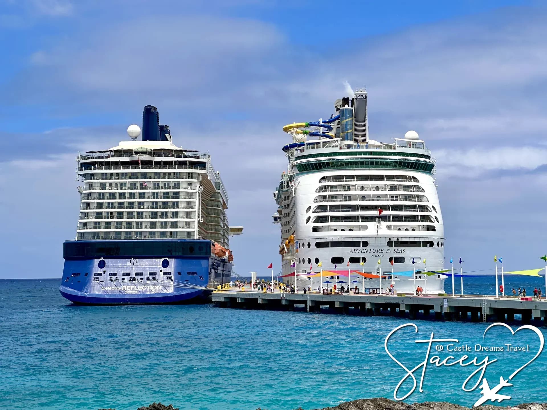 Two Celebrity Cruises ships docked side by side beside bright turquoise Caribbean water