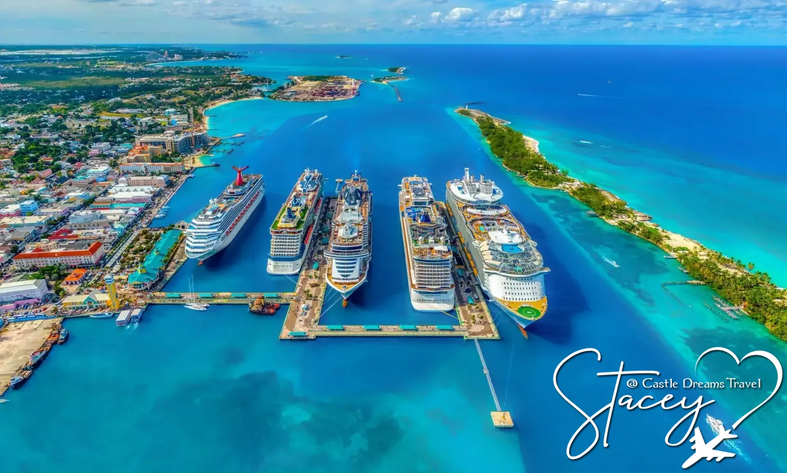 Aerial view of five cruise ships docked in a turquoise Caribbean harbor
