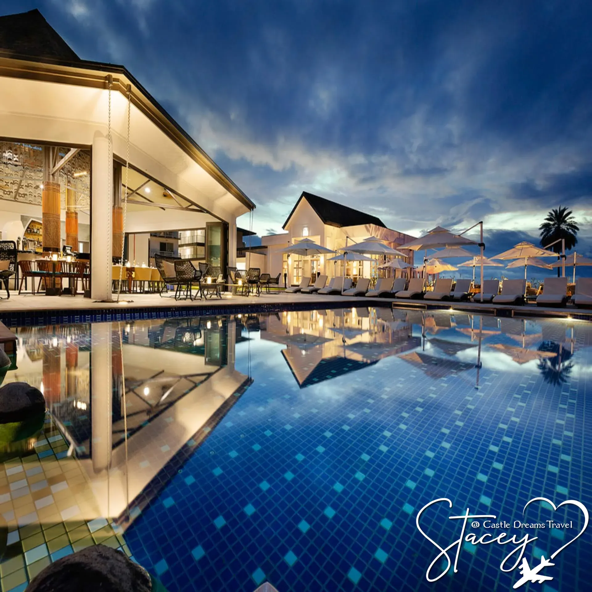 Quiet adults-only resort pool with loungers at the water's edge