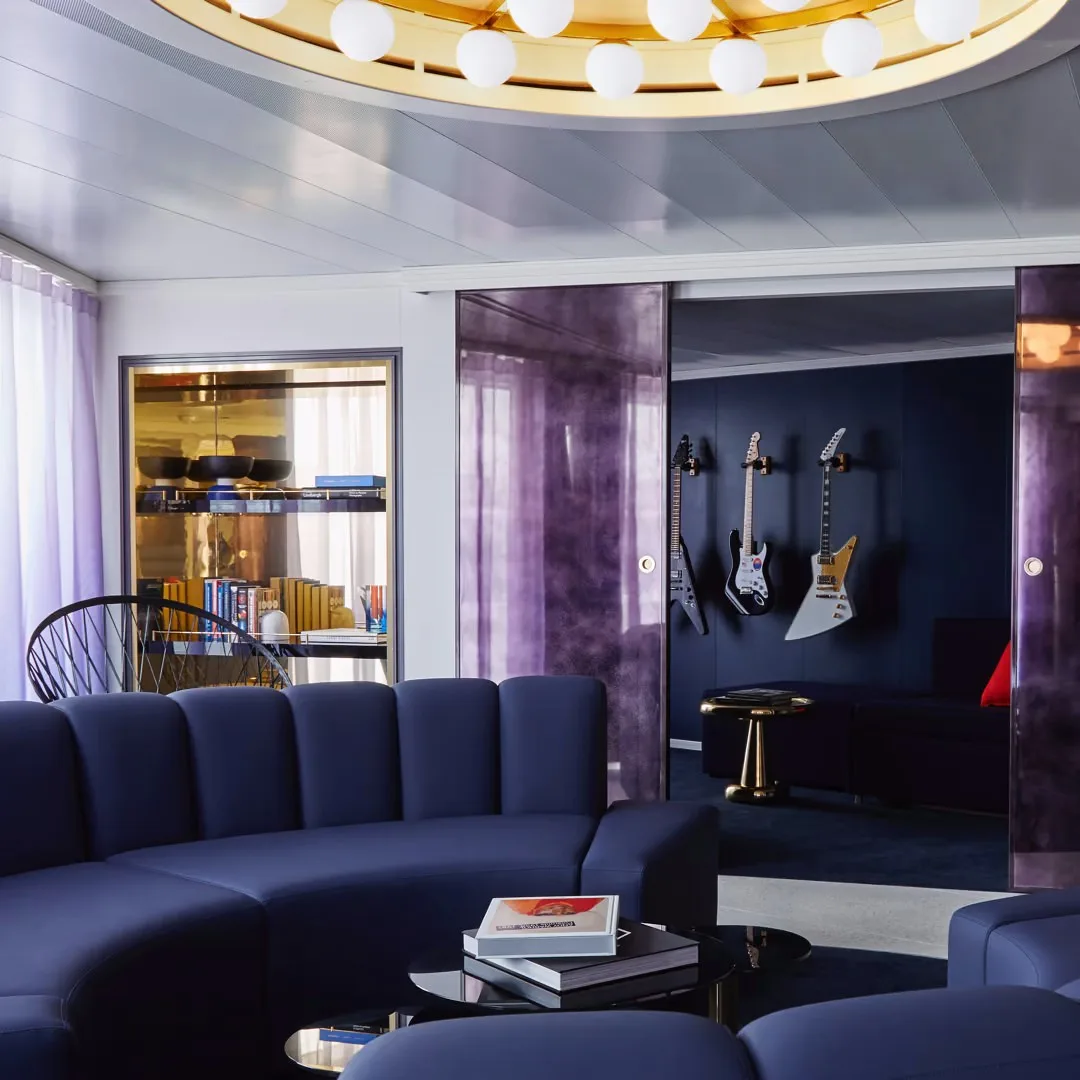 RockStar suite lounge aboard a Virgin Voyages ship, with guitars on the wall