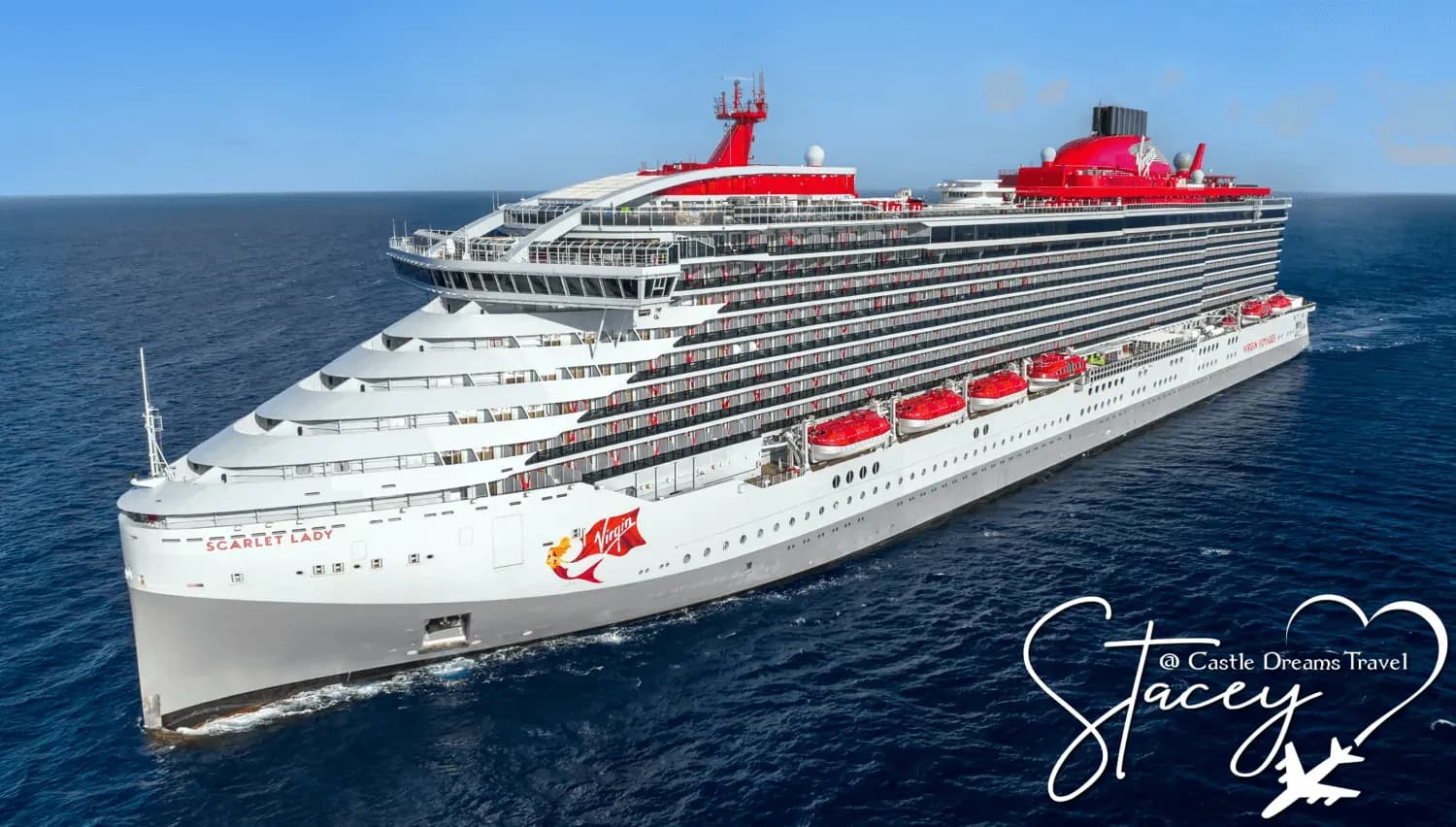 Virgin Voyages' Scarlet Lady at sea, with her grey hull, red funnel, and red Virgin logo