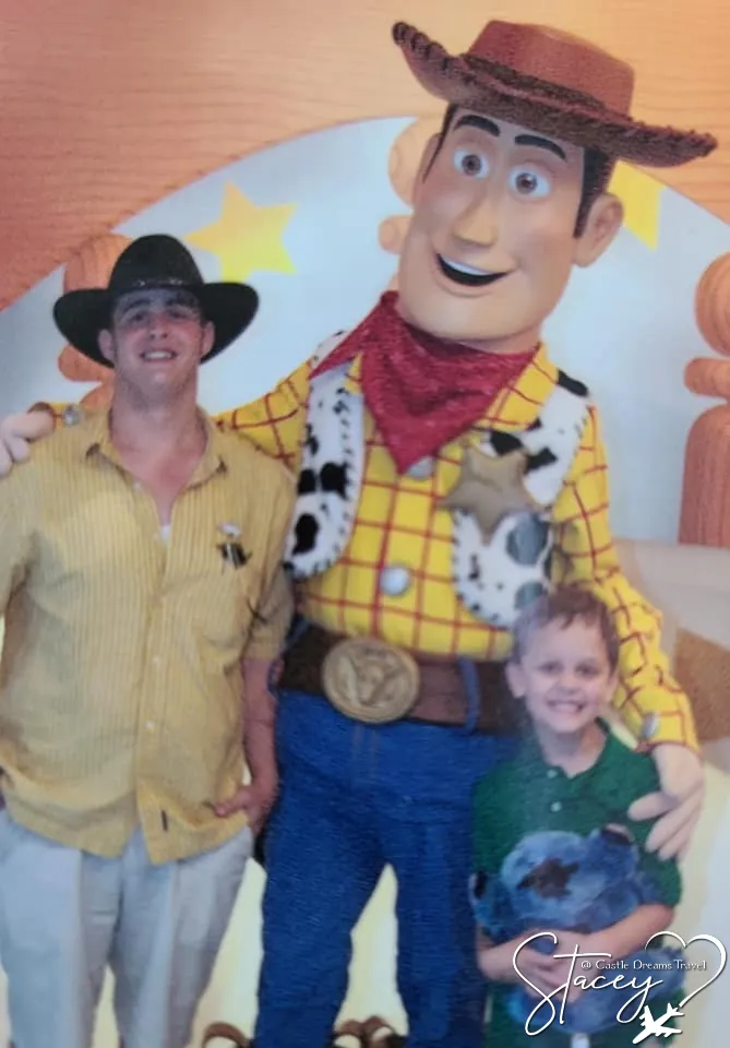 Stacey's two sons posing with Woody from Toy Story, the younger one in a green shirt holding a plush