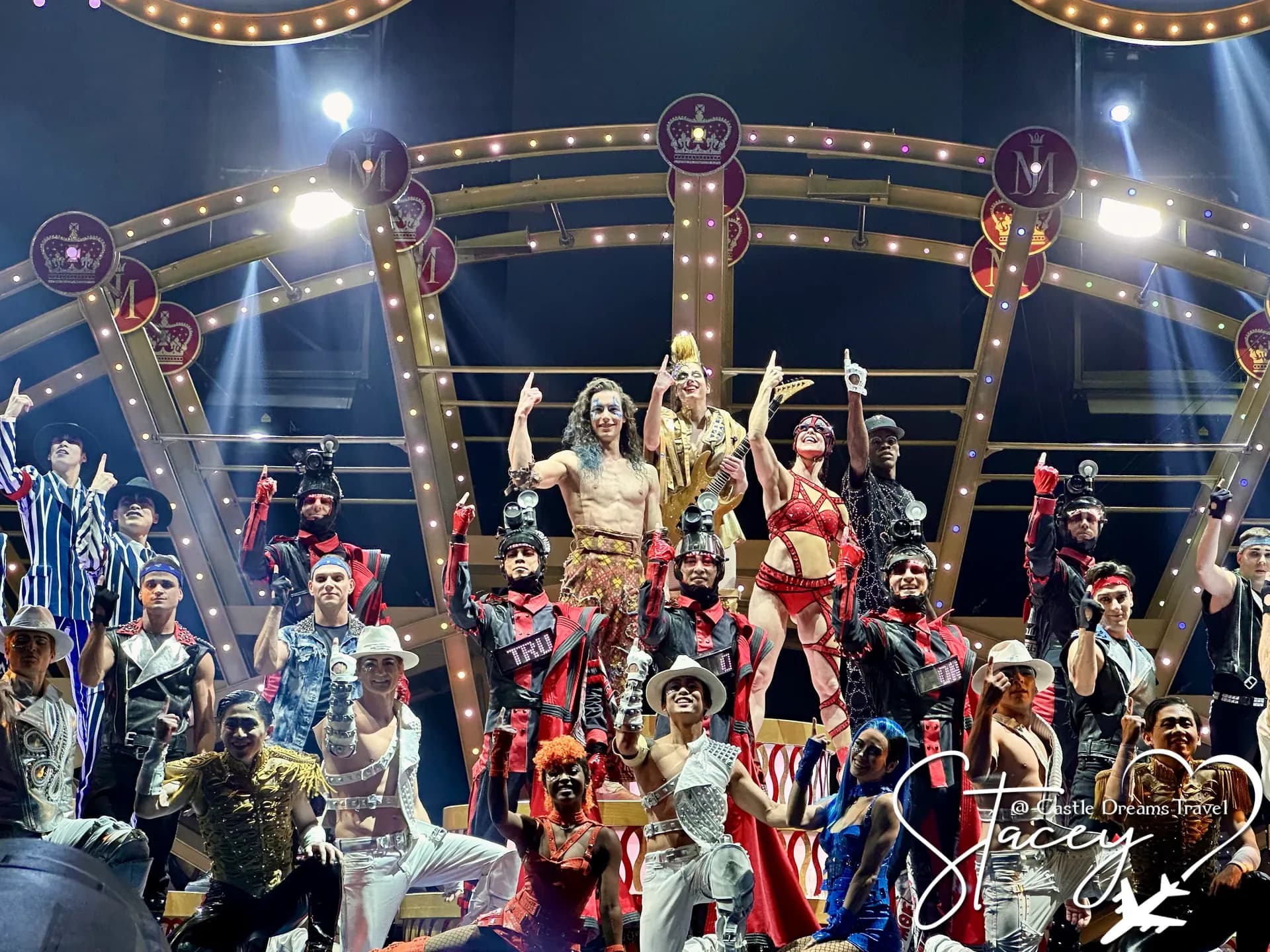 The full cast of a Las Vegas production show gathered on a brightly lit stage for the finale