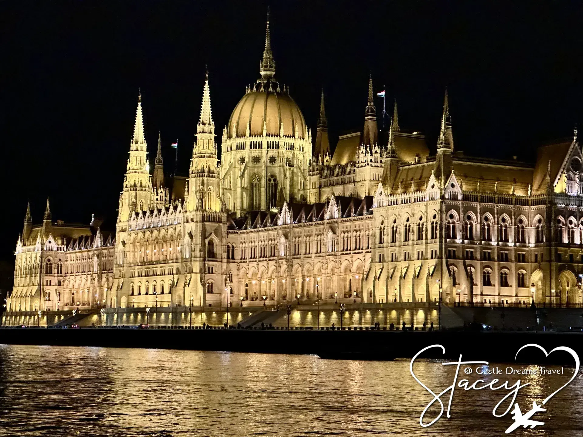 Hungarian Parliament Building glowing at night along the Danube, Budapest