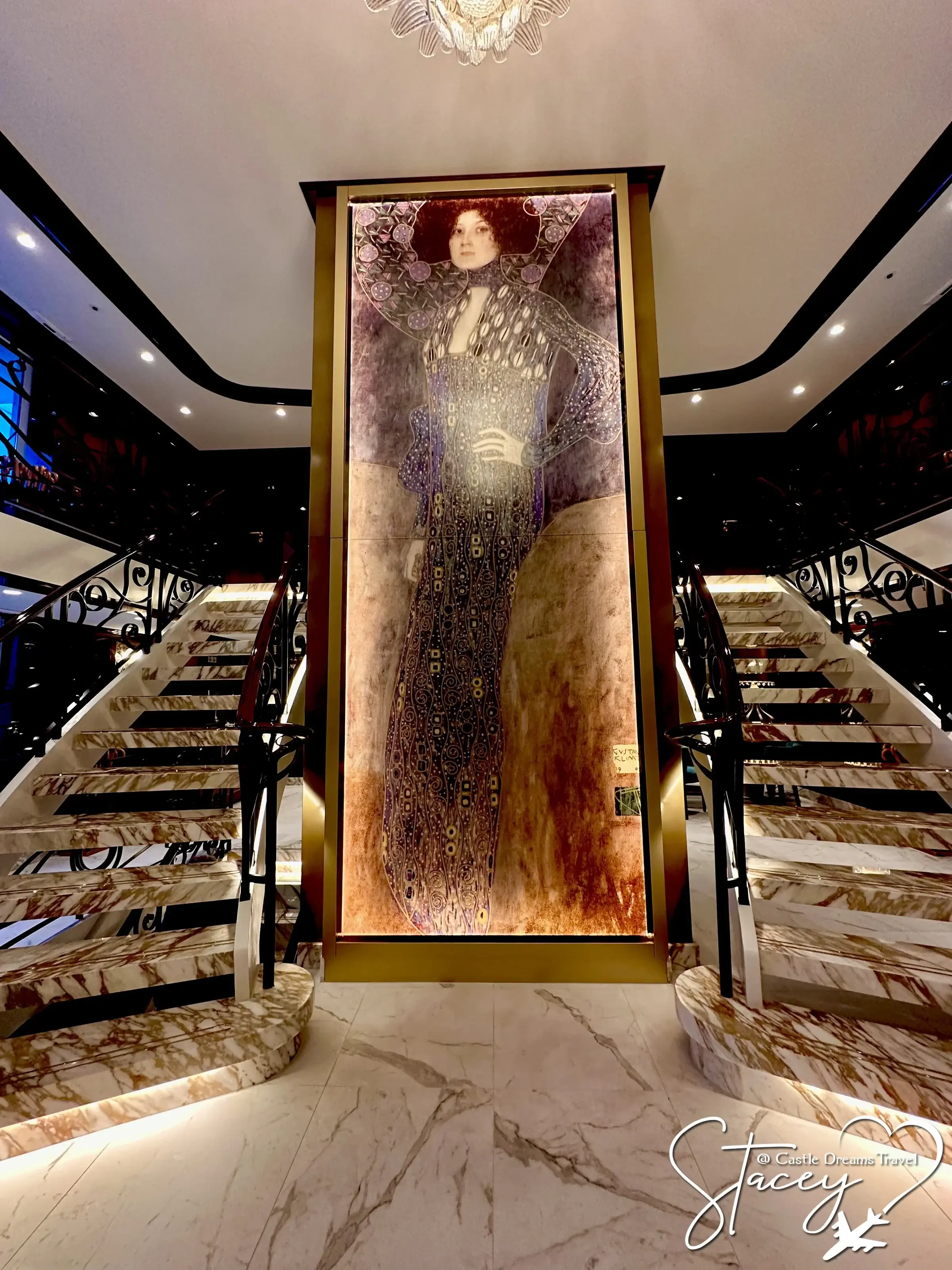 Uniworld's marble staircase framing a gilded Klimt-style portrait