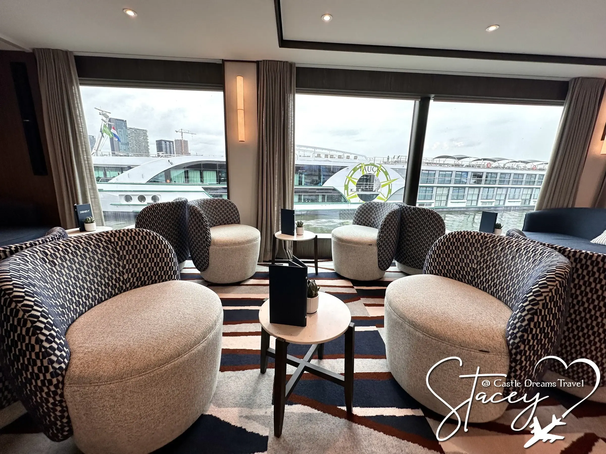 Rounded armchairs and river views in the lounge of a Viva Cruises ship
