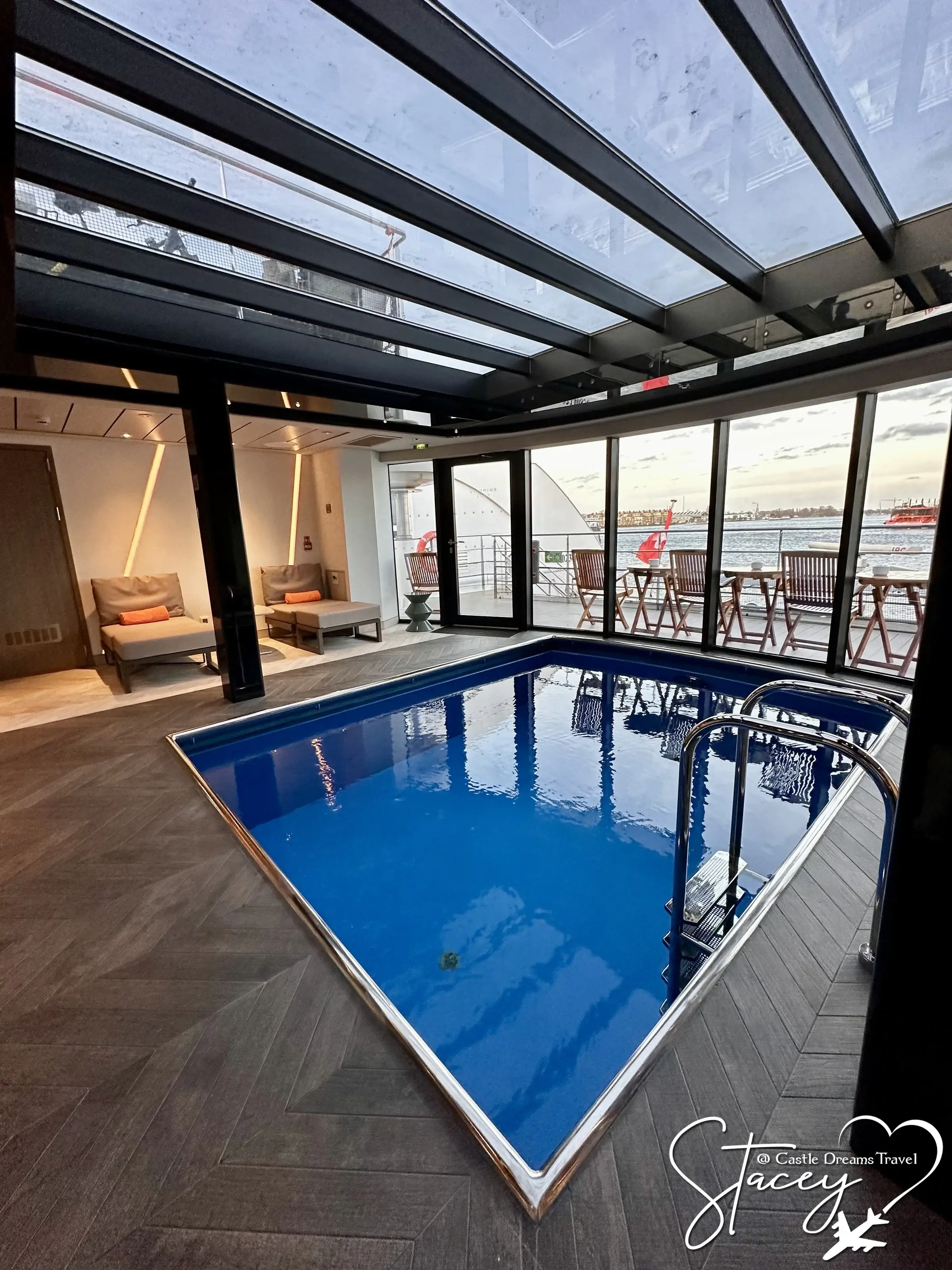 An indoor swimming pool under a glass roof aboard a Riverside river ship